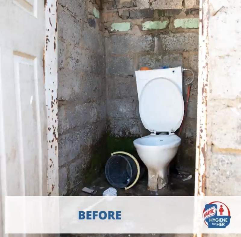 Broken toilet in a crumbling open brick enclosure, before the programme