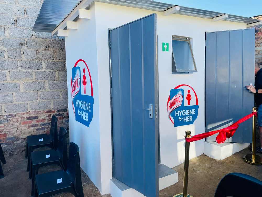 Women-only sanitation facility with Harpic Hygiene for Her branding and opening-day ribbon